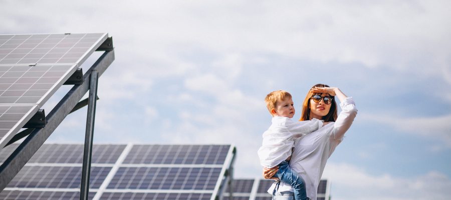 Mother with her little son by solar panels